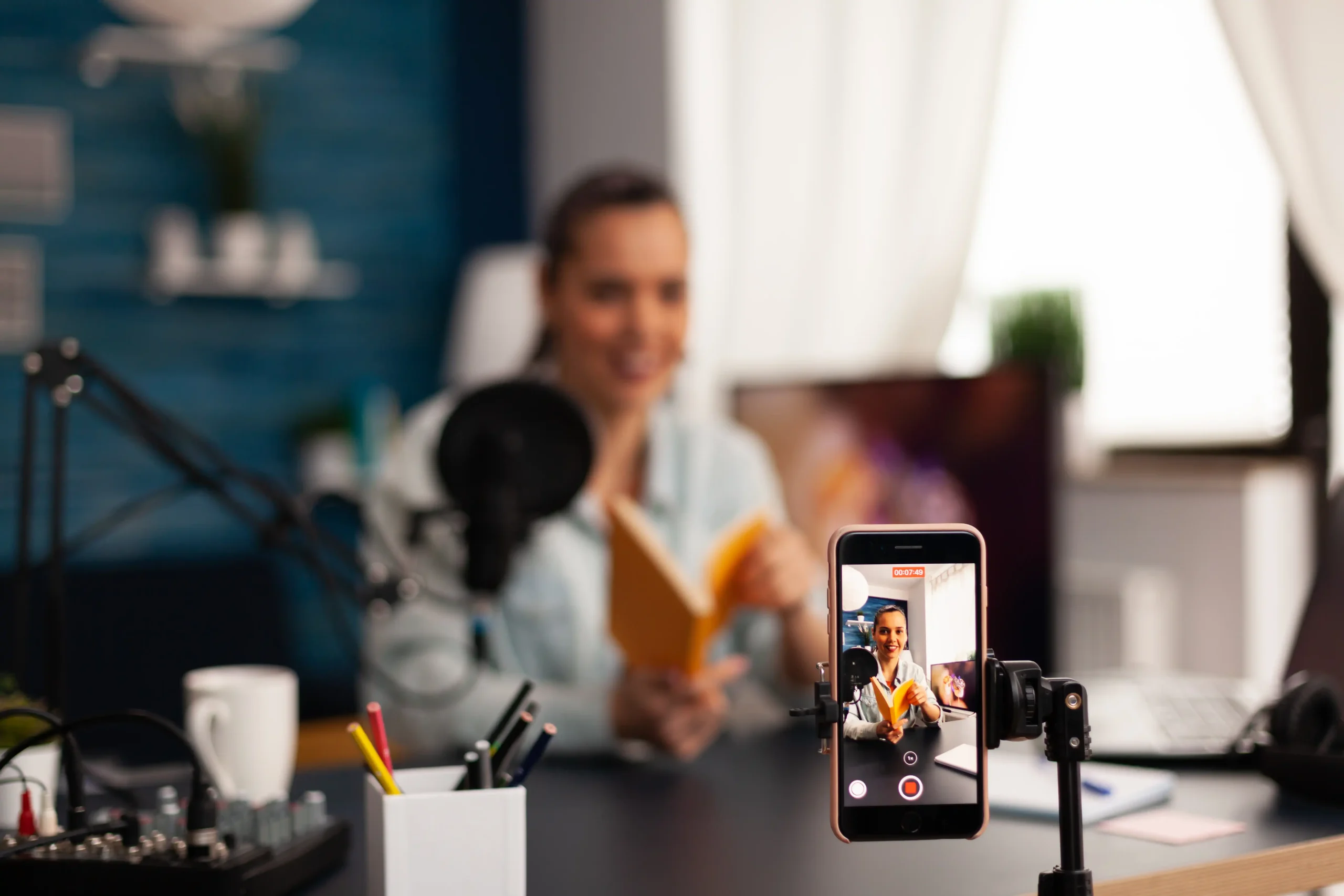 vlogger-holding-book-podcast-review-social-media-creative-content-creator-influencer-streaming-live-video-recording-digital-social-media-communication-her-audience